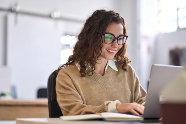 Woman working at a laptop.