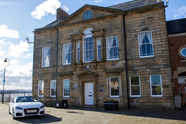 The exterior of the Maritime Chambers with a white car in the foreground 