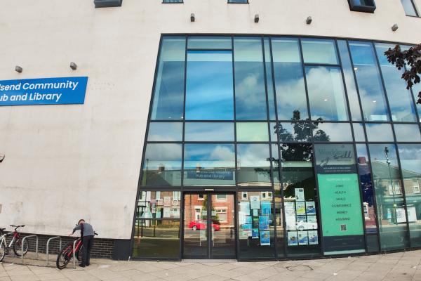 A building with large windows and a sign that says Wallsend community hub and library