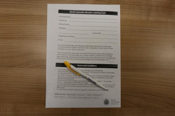 application form on a desk with a pen