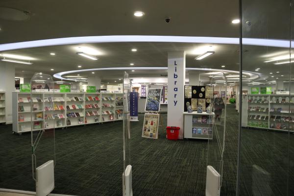 the inside of a library with rows and shelves of books