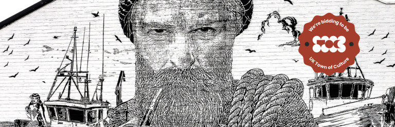 A mural of a fisherman smoking from a pipe, painted onto the side of a brick building.