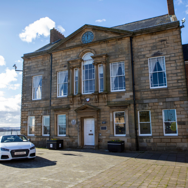 The exterior of the Maritime Chambers with a white car in the foreground 